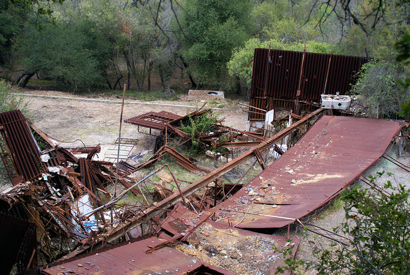 The rusted and twisted remains of a residential structure